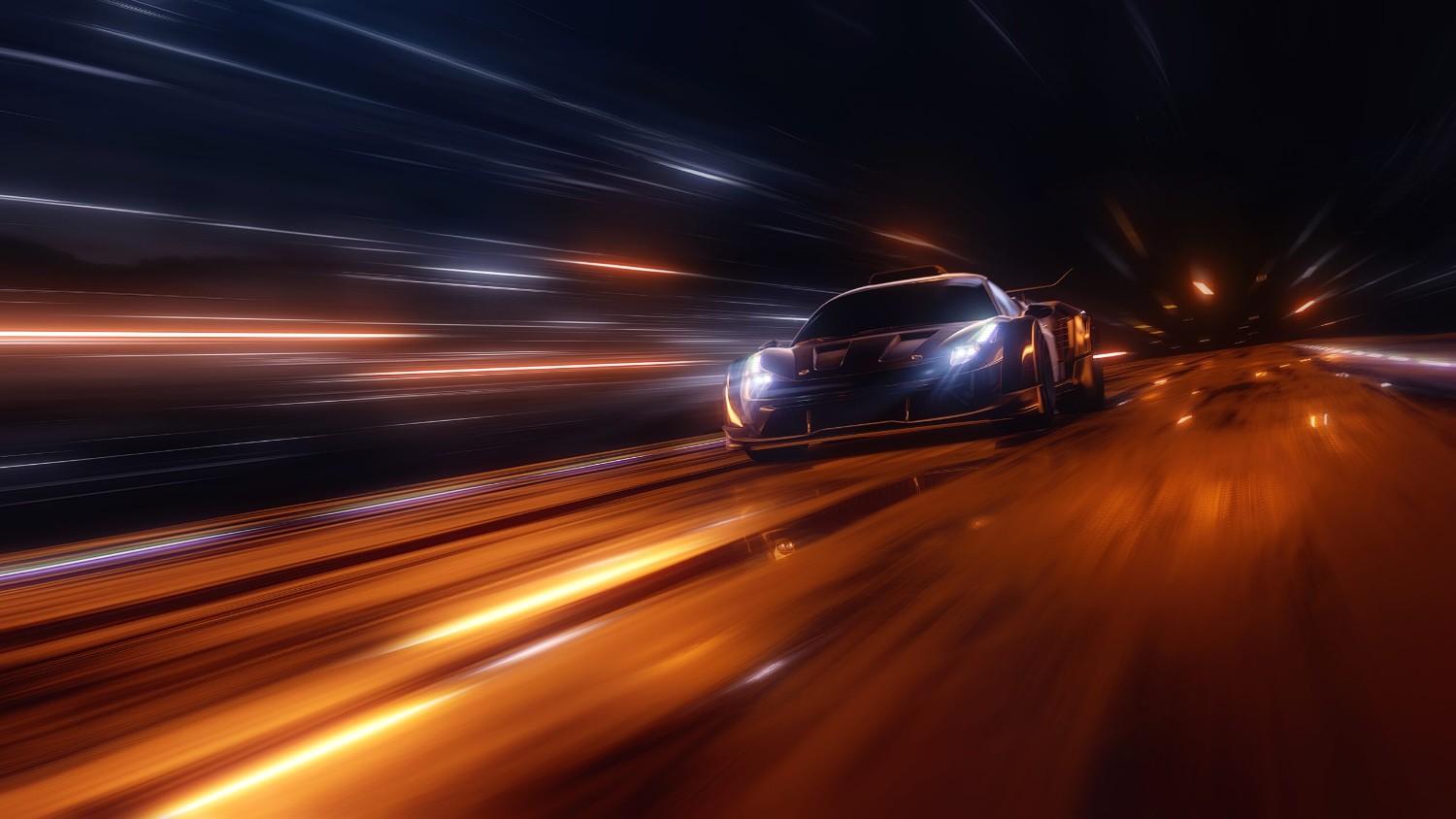 A sports car drives on a highway at night.