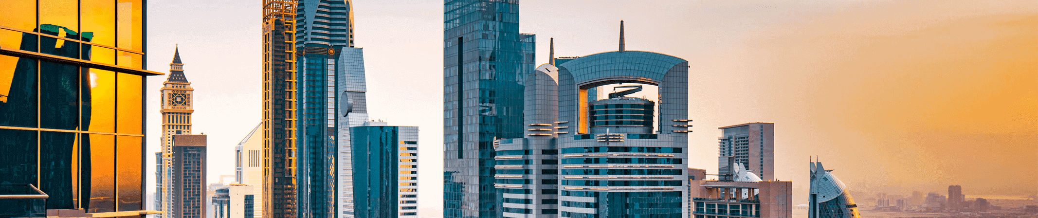 Panorama shot of skyscrapers in a city skyline at dusk.