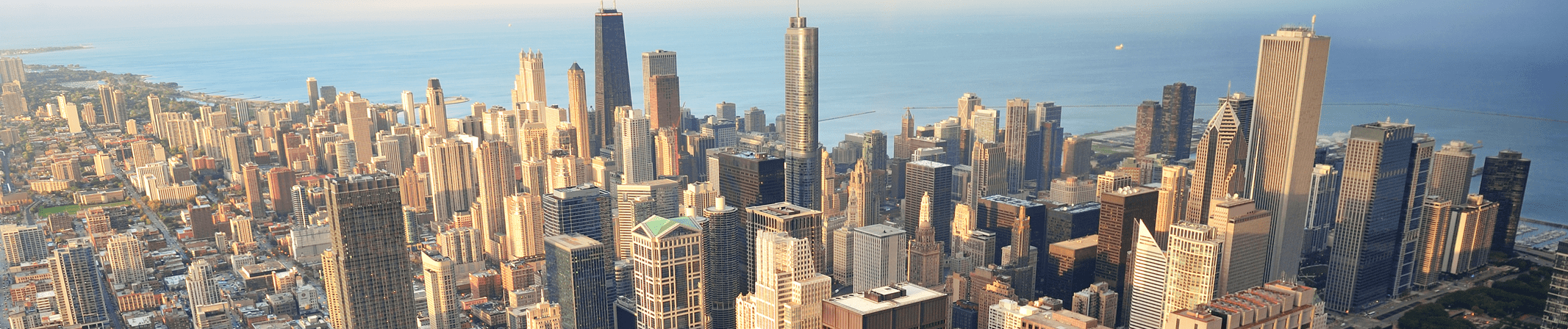 A panorama of a city skyline at sunset.