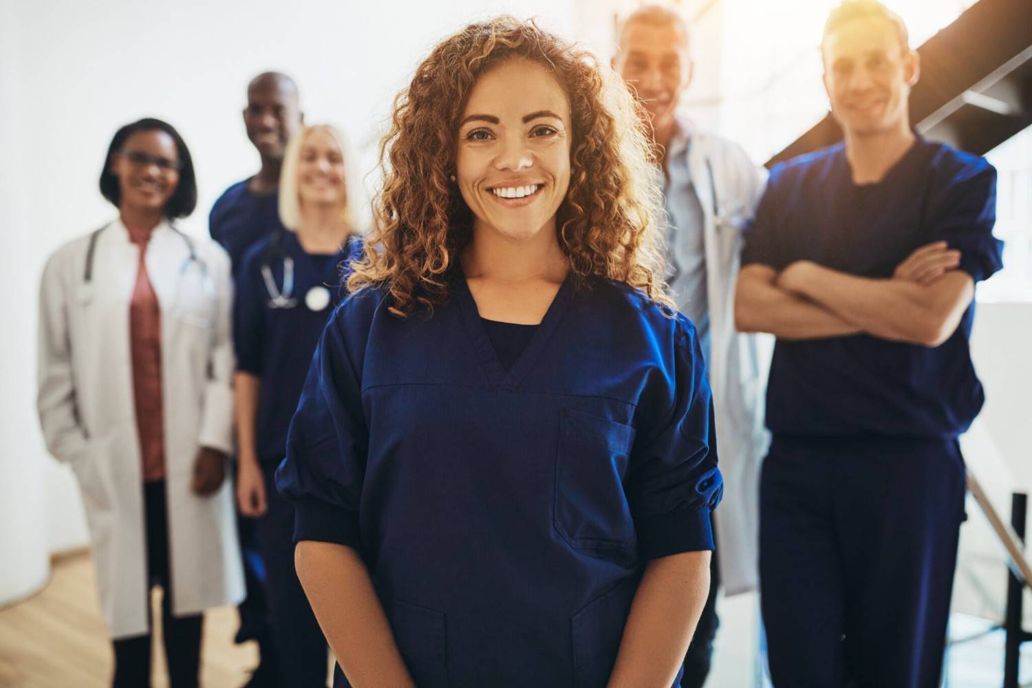 A group of healthcare workers smiles at the camera.