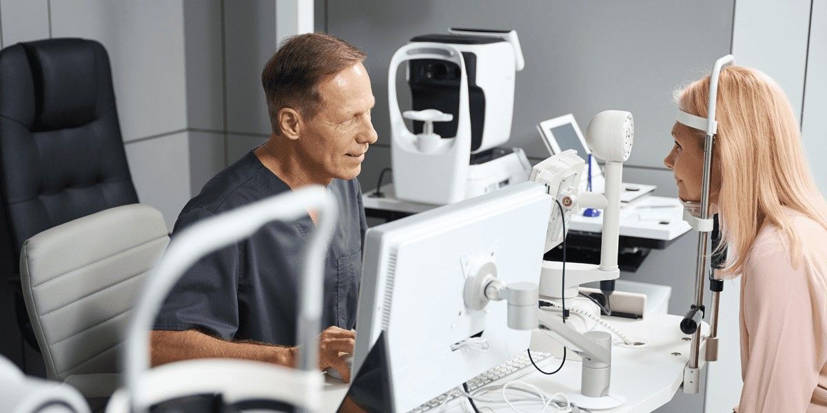 A woman has her eyes examined by an ophthalmologist.