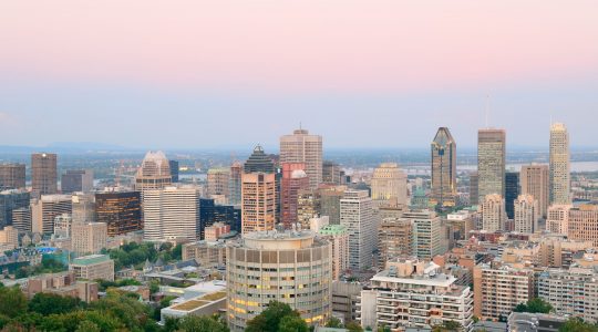 Montreal city skyline at sunset viewed from Mont Royal with urban skyscrapers.