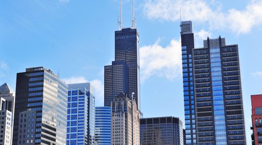 Chicago city downtown urban skyline with skyscrapers and cloudy blue sky.